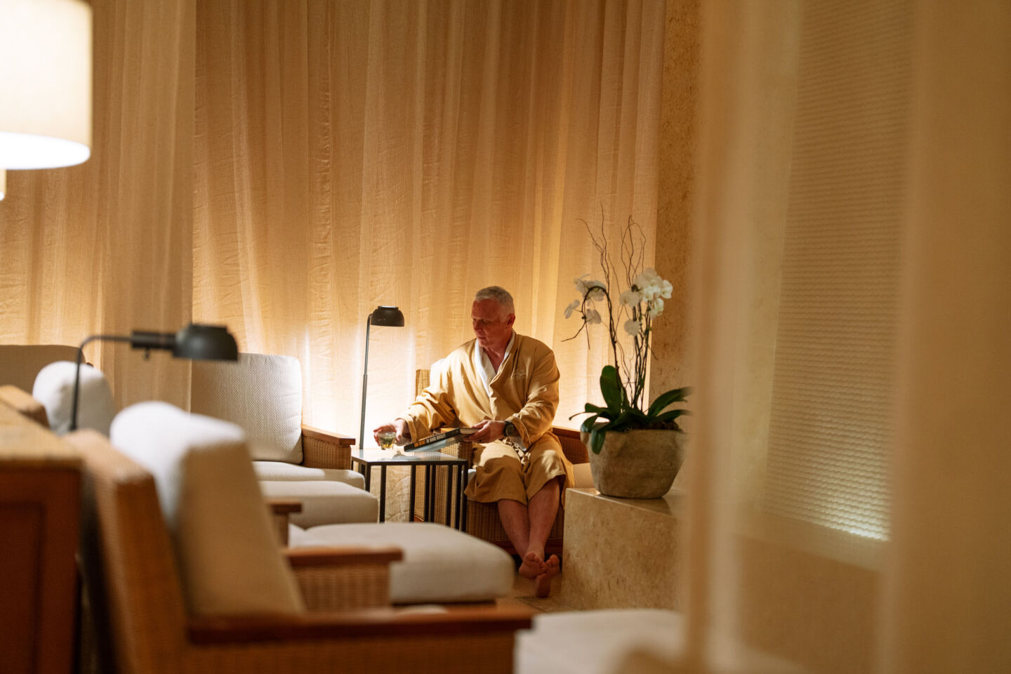 man lounging in pelican hill spa lounge